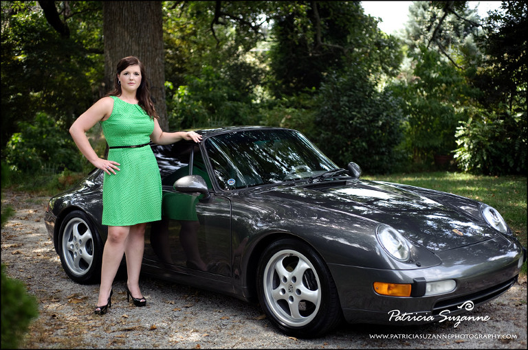 woman in green dress standing in front of porsche
