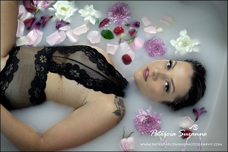 Face in milk bath boudoir surrounded by flowers